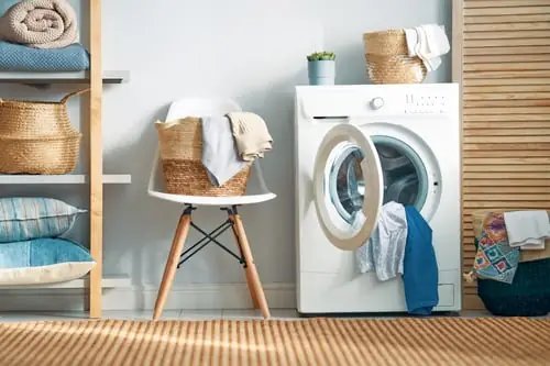 Home laundry room with a front-load washer serviced by Liranzo Appliance Repair